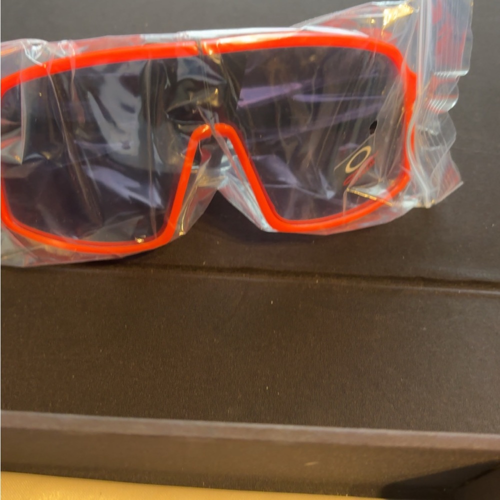 Oakley Red Frame Sunglasses with Dark Lenses